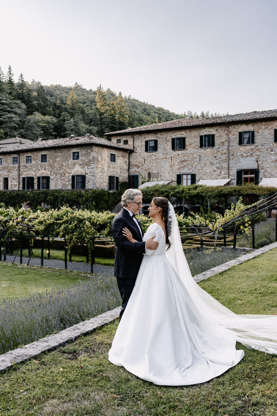 Bride and groom embracing in the gardens of a Tuscan castello