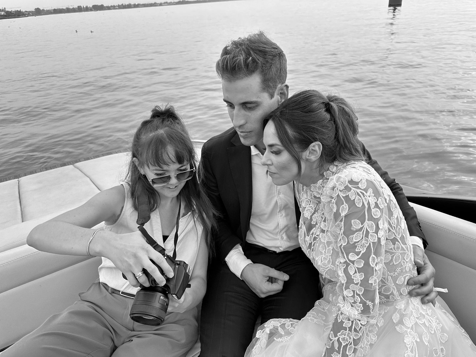 Greta showing a couple their first photographs on a boat